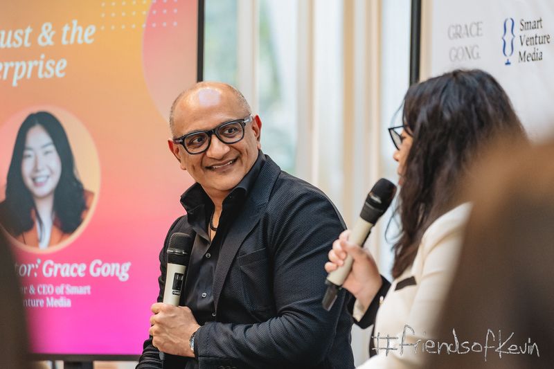Two speakers holding microphones during a panel discussion at the Smart AI Summit.