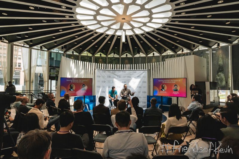 Audience watching an onstage discussion at the Smart AI Summit in a modern venue with a geometric ceiling.