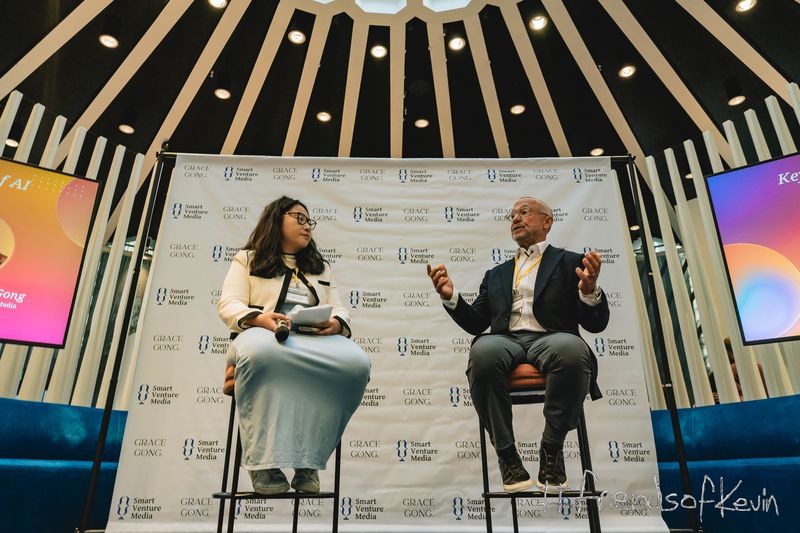 Alt text: Two speakers seated onstage during a panel discussion at the Smart AI Summit.