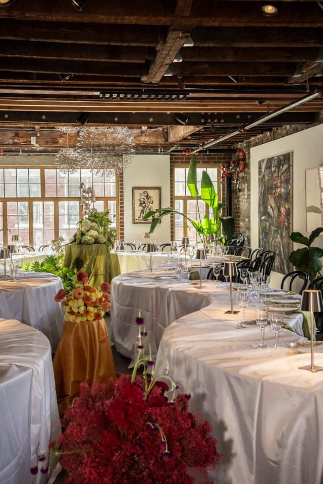 Floral arrangements and elegant tables set for the Pickle x Mostest NYFW kickoff dinner at Suprema Provisions in NYC.